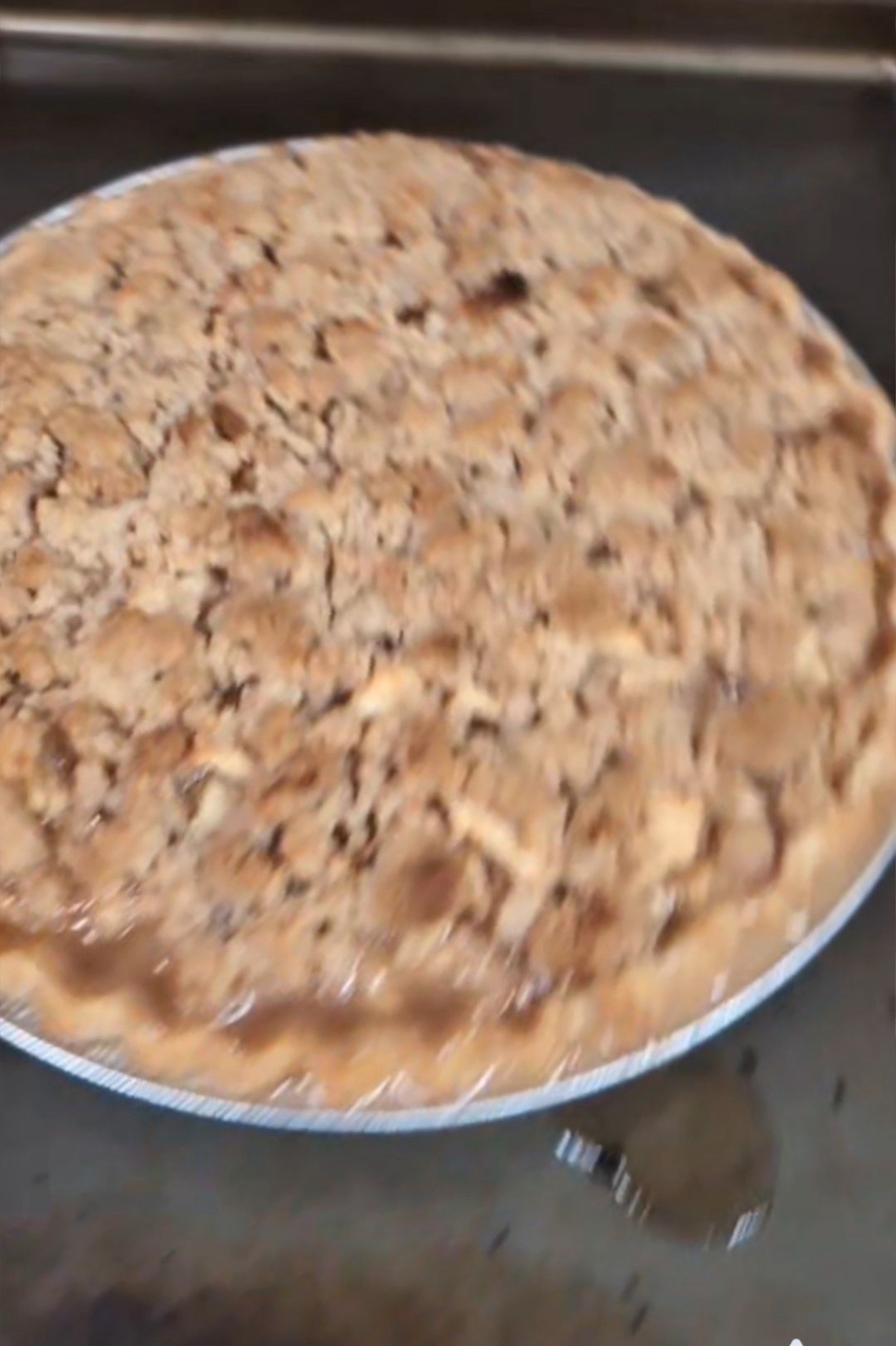 Homemade pie with filling leaking over the edge
